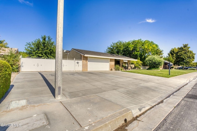 43737 W 27th St, Lancaster, CA 93536 - ranch-style home featuring brick siding, an attached garage, a gate, and driveway