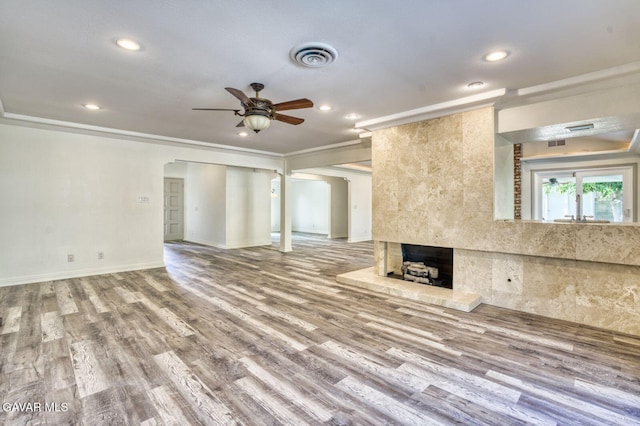43737 W 27th St, Lancaster, CA 93536 - unfurnished living room featuring ceiling fan, a tile fireplace, recessed lighting, wood finished floors, and crown molding