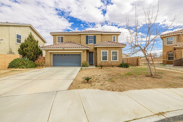 mediterranean / spanish-style home with an attached garage, driveway, fence, and stucco siding