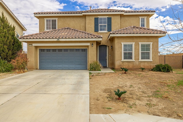 mediterranean / spanish-style house with a garage, fence, driveway, a tiled roof, and stucco siding