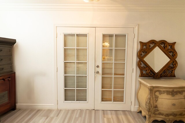 doorway featuring french doors, light hardwood / wood-style floors, and ornamental molding
