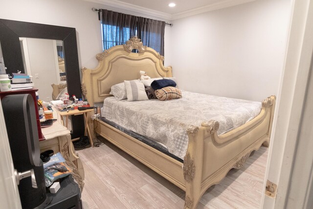 bedroom featuring light hardwood / wood-style floors and ornamental molding