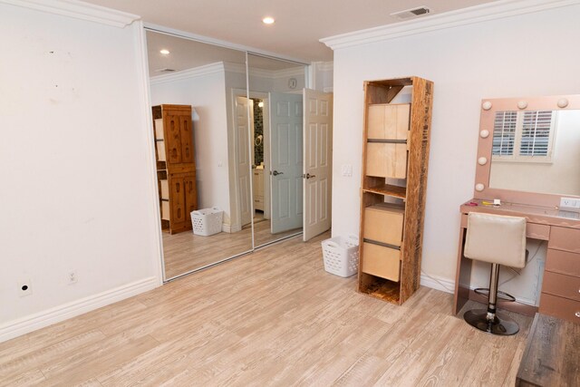 interior space with light wood-type flooring and crown molding