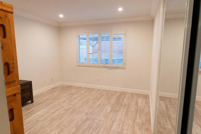 unfurnished room with light hardwood / wood-style floors and ornamental molding