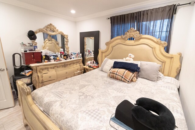 bedroom featuring light hardwood / wood-style floors and ornamental molding