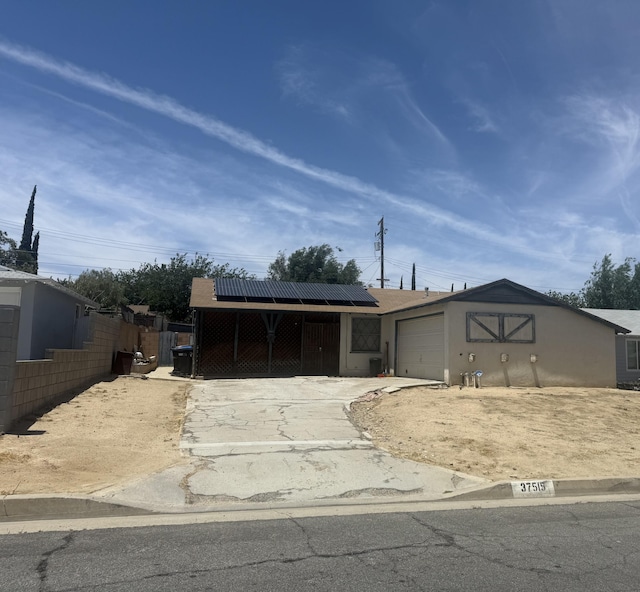 37515 Larkin Ave, Palmdale, CA 93550 - single story home with concrete driveway, an attached garage, and roof mounted solar panels