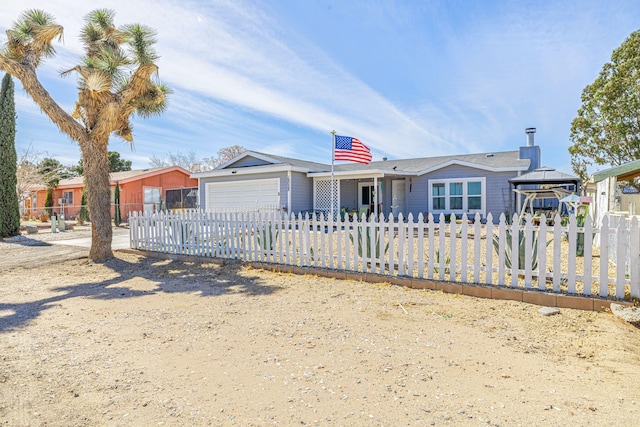 ranch-style house featuring a gazebo, a fenced front yard, and an attached garage