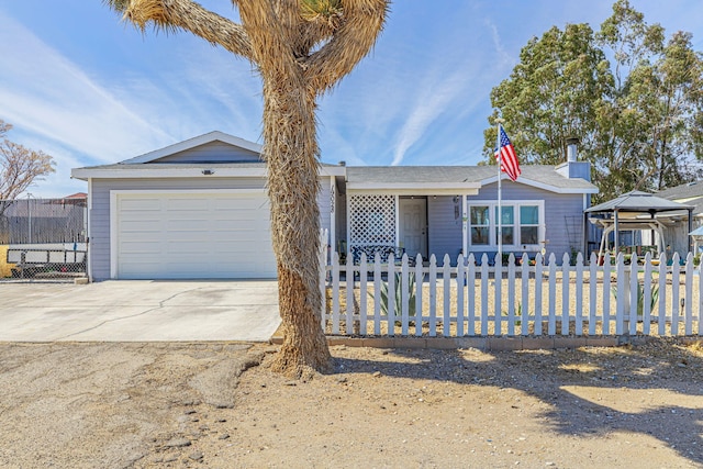 single story home with a fenced front yard, driveway, and an attached garage