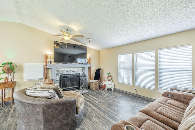 living room with a fireplace with flush hearth, a ceiling fan, a textured ceiling, wood finished floors, and vaulted ceiling