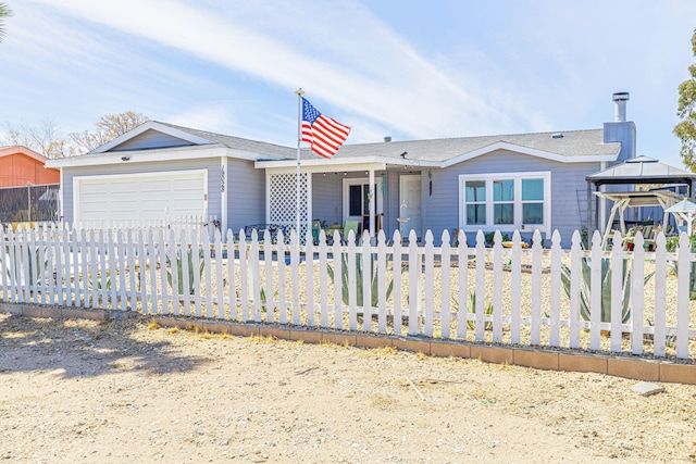 ranch-style home with a fenced front yard, a gazebo, and a garage