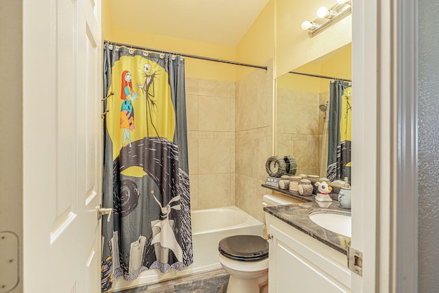 bathroom featuring shower / tub combo, toilet, and vanity