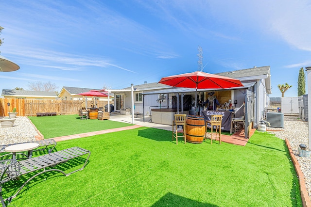 back of property featuring a patio, a fenced backyard, a lawn, and central AC