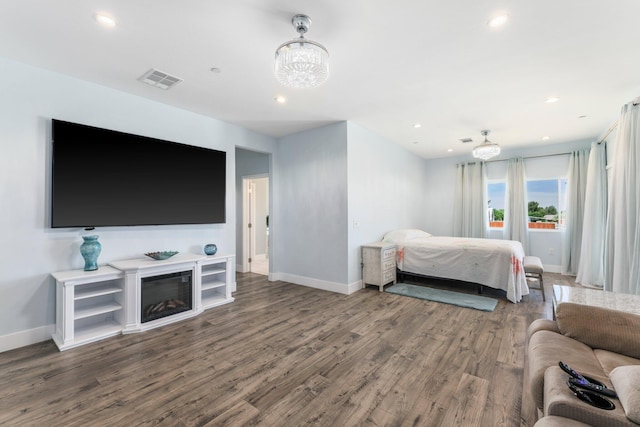 bedroom featuring a chandelier, wood finished floors, baseboards, and recessed lighting