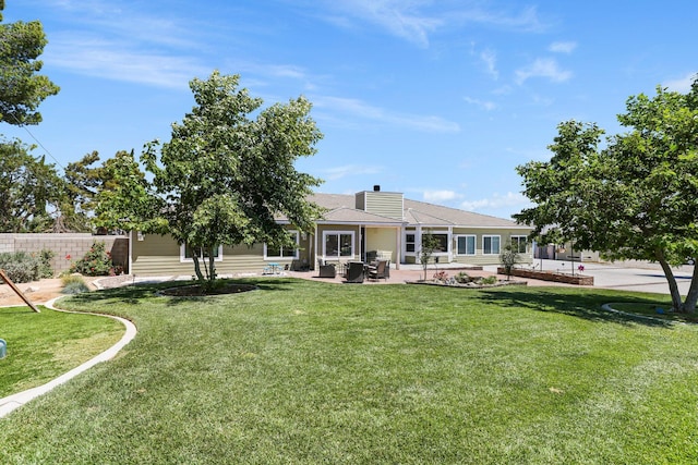 back of house featuring a patio and a chimney