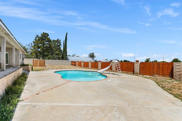 view of swimming pool featuring a water slide, a fenced backyard, and a patio