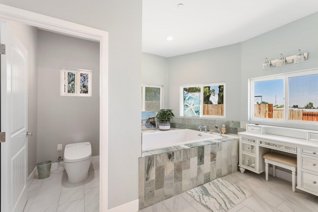 full bath featuring healthy amount of natural light, a garden tub, and toilet