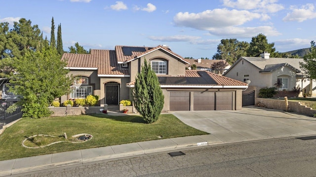 42164 Valley Vista Dr, Lancaster, CA 93536 - mediterranean / spanish-style home featuring solar panels, stucco siding, an attached garage, concrete driveway, and a tiled roof