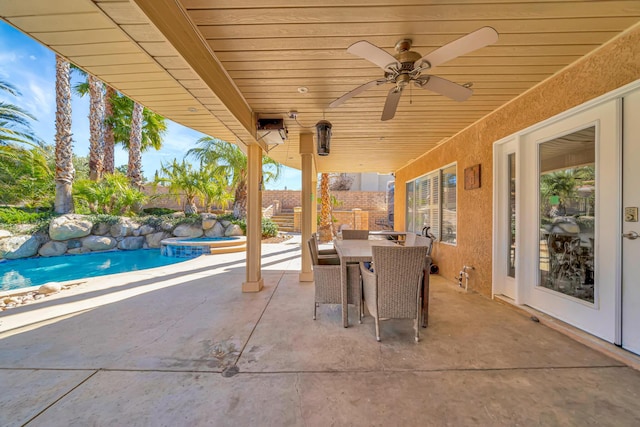 view of patio with outdoor dining space, fence, a fenced in pool, and a ceiling fan