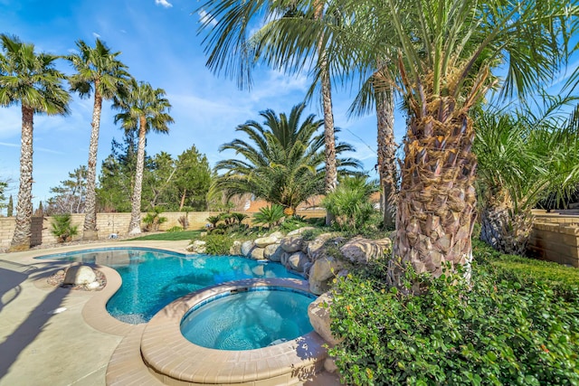 view of pool featuring an in ground hot tub, a fenced backyard, and a fenced in pool