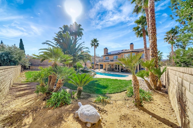 view of yard featuring a patio area, a fenced backyard, and a fenced in pool