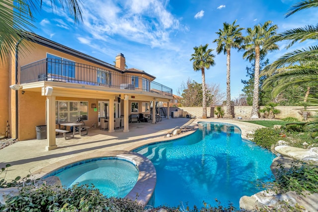 view of pool with a fenced in pool, a patio, a fenced backyard, stairway, and an in ground hot tub