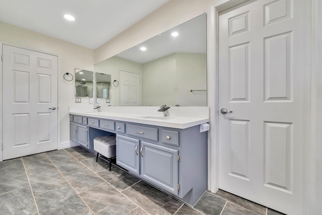 bathroom featuring recessed lighting, a sink, and double vanity