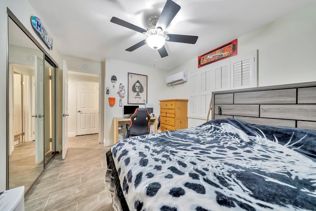 bedroom featuring an AC wall unit, ceiling fan, and baseboards