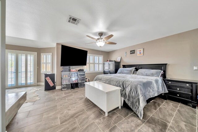 bedroom with baseboards, visible vents, and ceiling fan