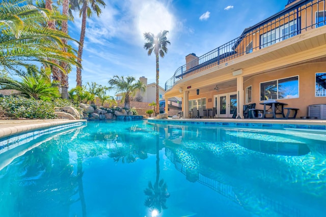 outdoor pool featuring ceiling fan, central AC, french doors, and a patio area