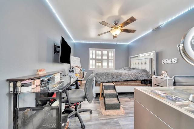 bedroom with ceiling fan and wood finished floors