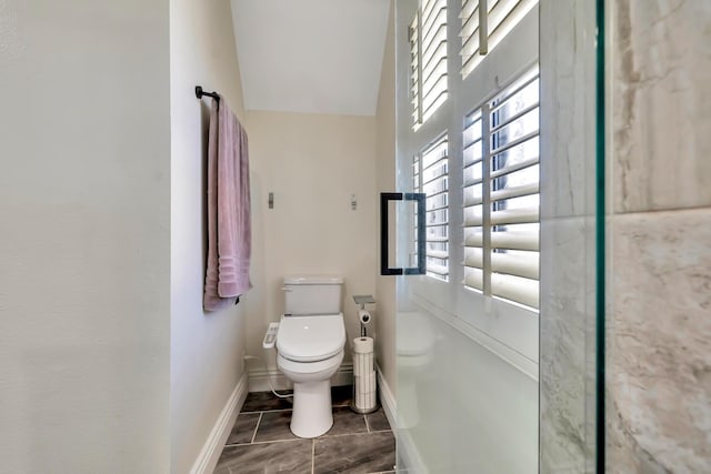 bathroom featuring baseboards and toilet