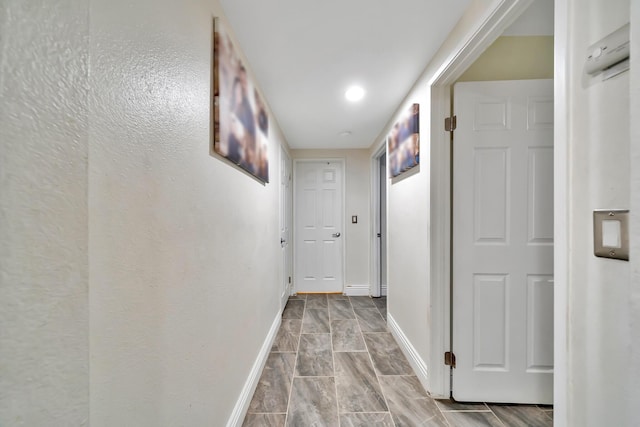 hall featuring baseboards