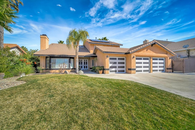 view of front of property featuring a garage, a front yard, concrete driveway, and a chimney