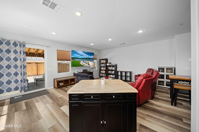 3432 Andrew Ave, Rosamond, CA 93560 - kitchen featuring dark cabinets, open floor plan, light wood-type flooring, recessed lighting, and a center island