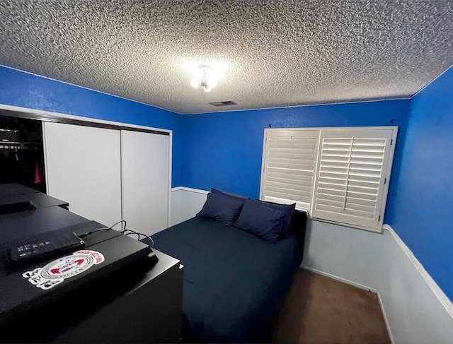 unfurnished bedroom featuring a closet and a textured ceiling