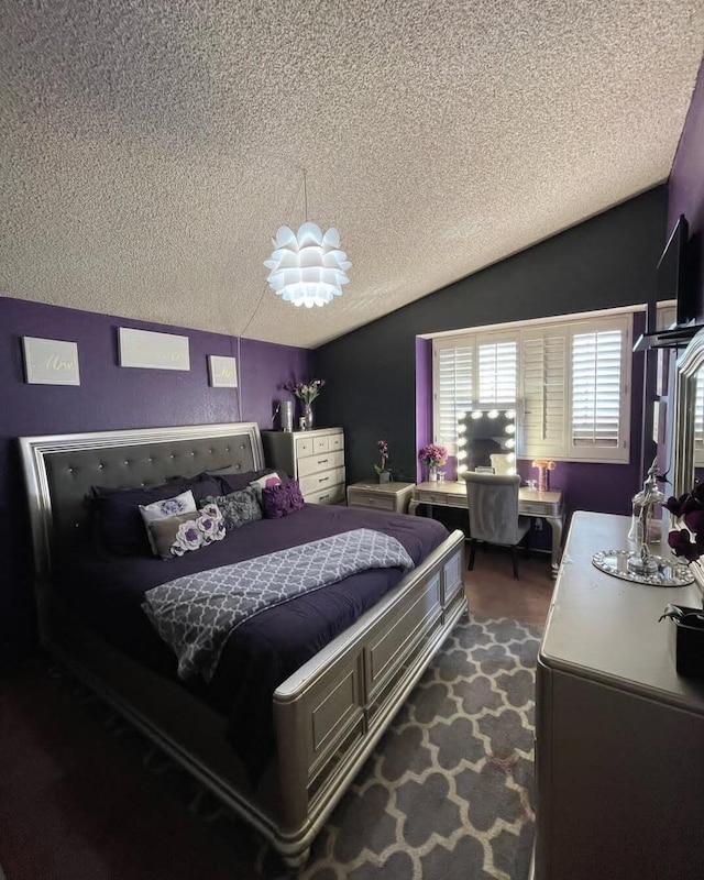 bedroom featuring lofted ceiling and a textured ceiling