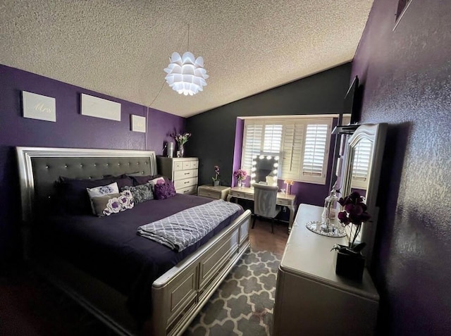 bedroom with a textured ceiling, dark wood-type flooring, and lofted ceiling