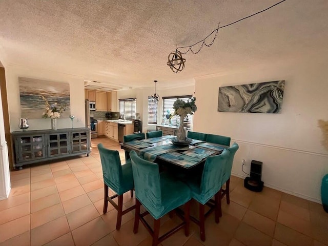 tiled dining space with a textured ceiling and an inviting chandelier