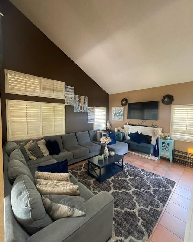 living room with tile patterned flooring and vaulted ceiling