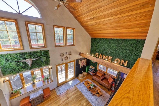 living room featuring hardwood / wood-style floors, high vaulted ceiling, ceiling fan, and wood ceiling