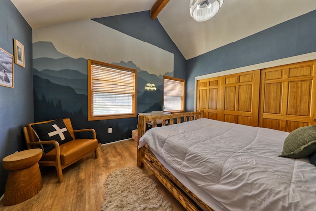 bedroom with vaulted ceiling with beams, a closet, and light hardwood / wood-style floors