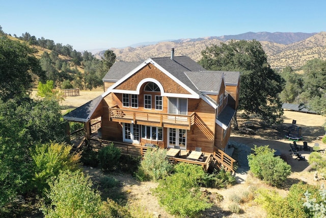 back of house with a deck with mountain view