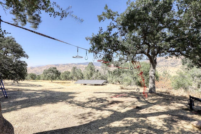 view of yard with a mountain view and a rural view