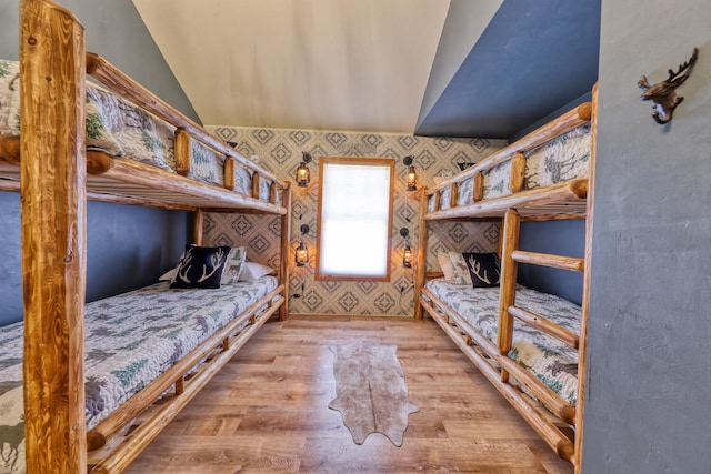 bedroom featuring lofted ceiling and light hardwood / wood-style flooring