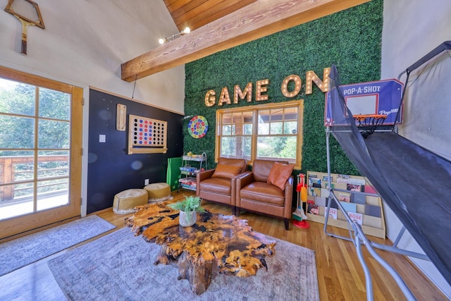 playroom with hardwood / wood-style floors and vaulted ceiling with beams