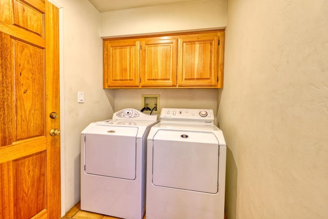 laundry room with cabinets and washing machine and dryer