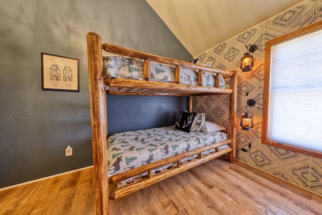 bedroom featuring hardwood / wood-style floors and vaulted ceiling