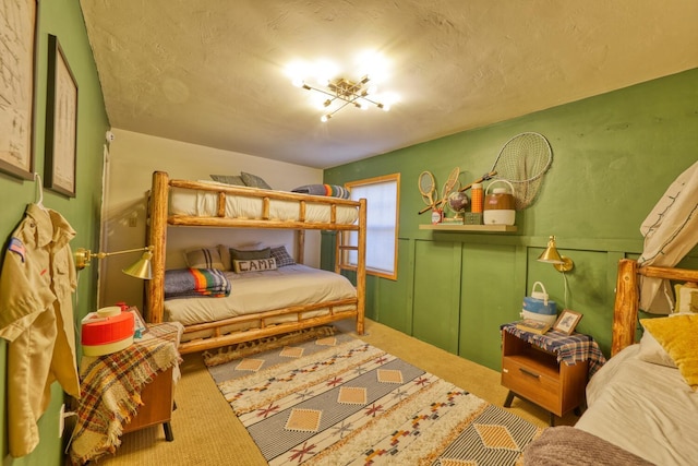 bedroom featuring carpet floors and a textured ceiling