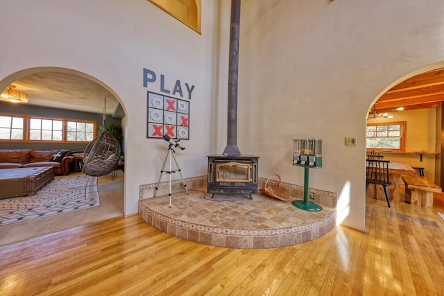 interior space with hardwood / wood-style flooring and a wood stove