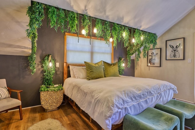 bedroom featuring wood-type flooring and lofted ceiling